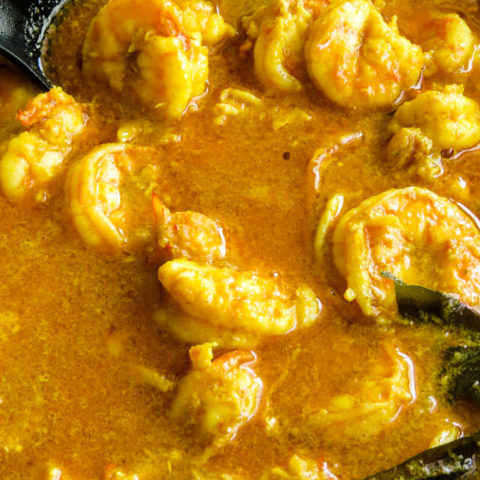 shrimp coconut curry cooking in a pan.