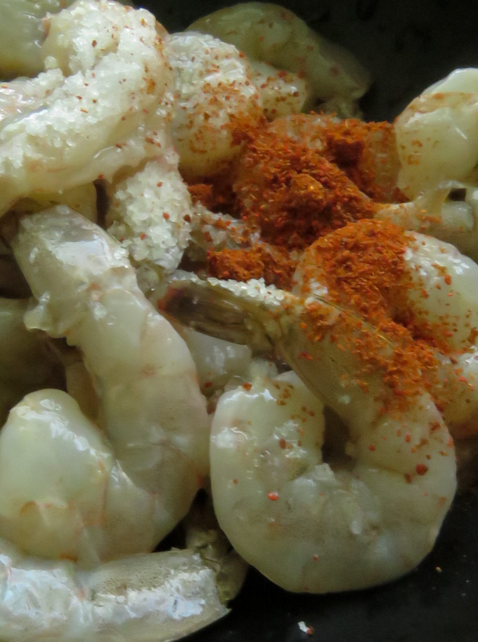seasoning the cleaned shrimp with salt and chilli powder.