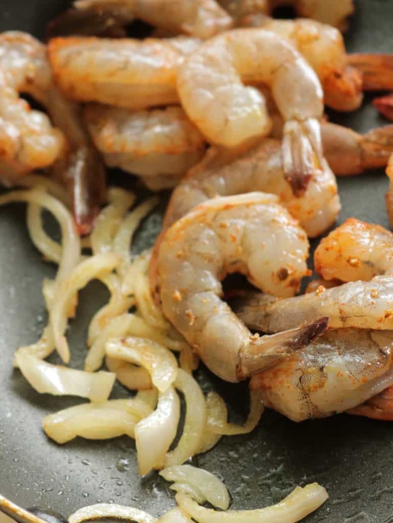 sauteed shirmp with onions and spices.
