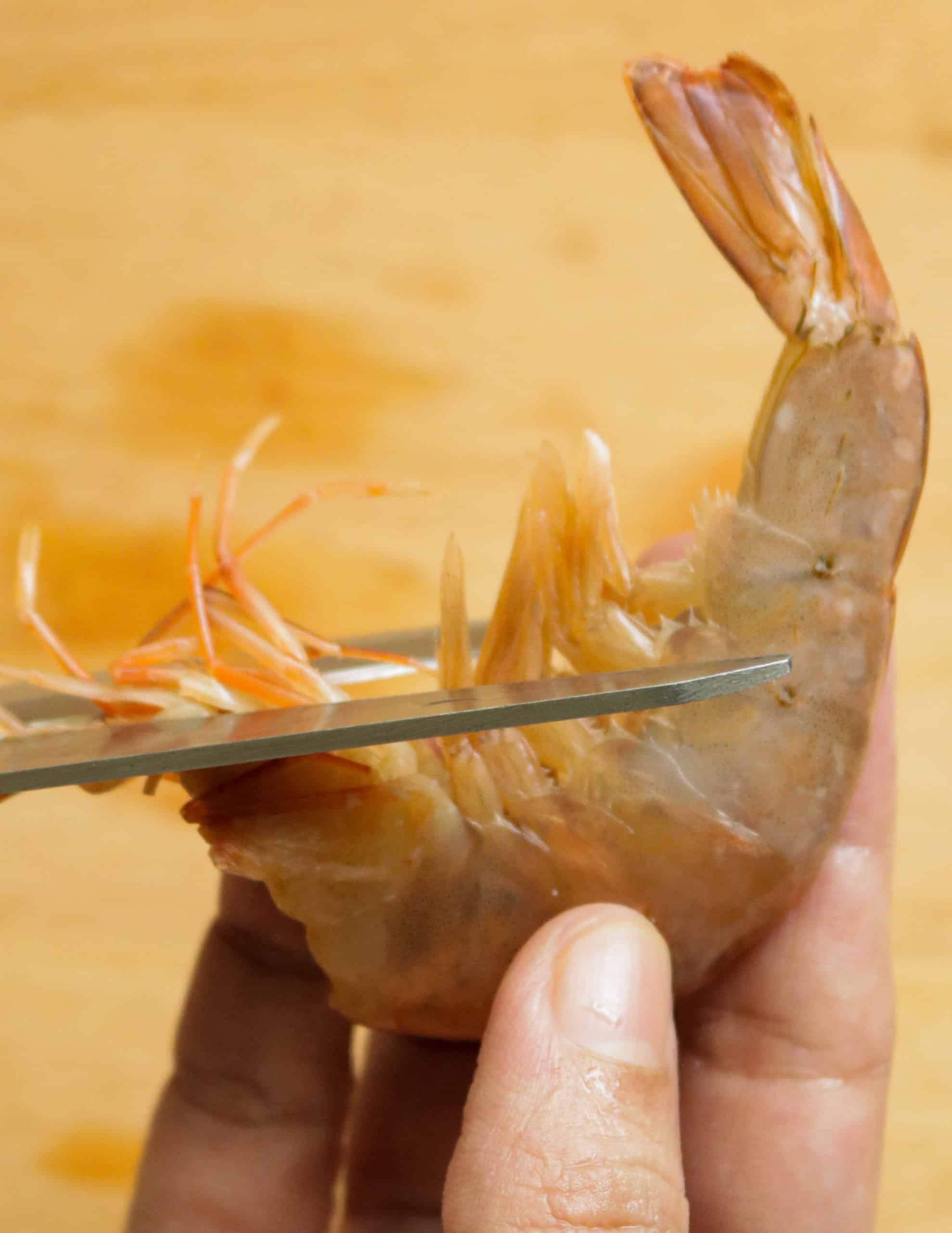 cutting the shrimp legs to clean shrimp