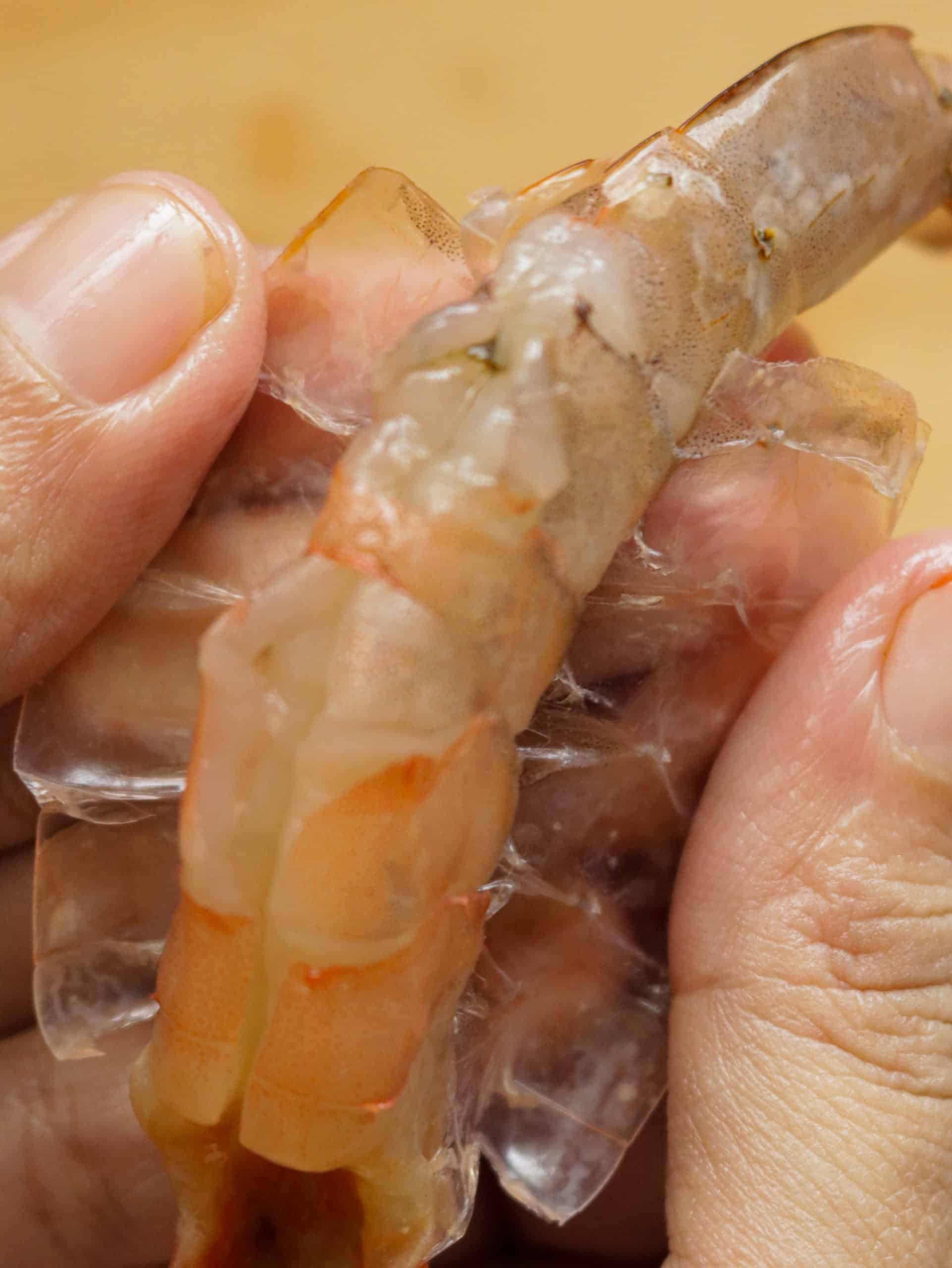 removing the shell of the shrimp