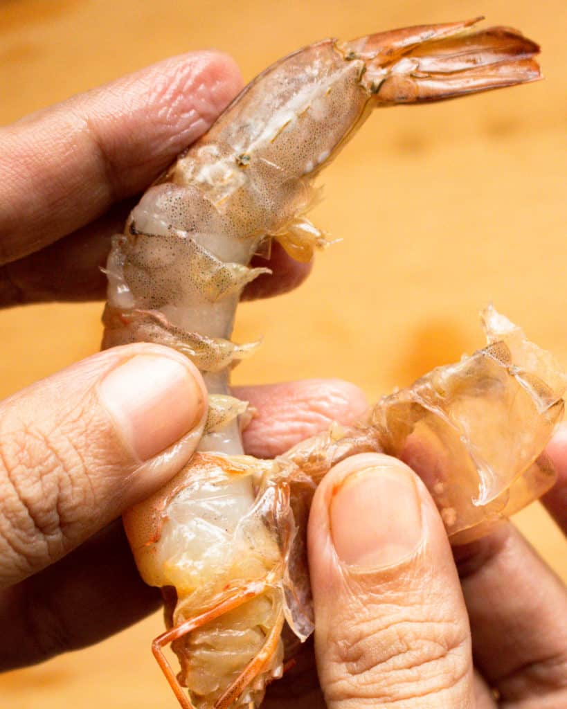 the shell being completely removed from the shrimp.