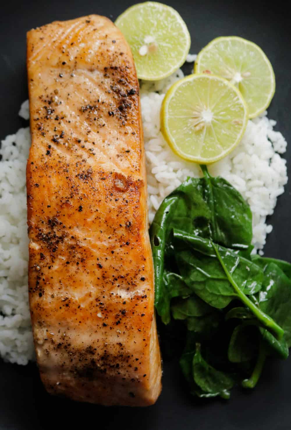 pan seared salmon serve with rice and spinach.