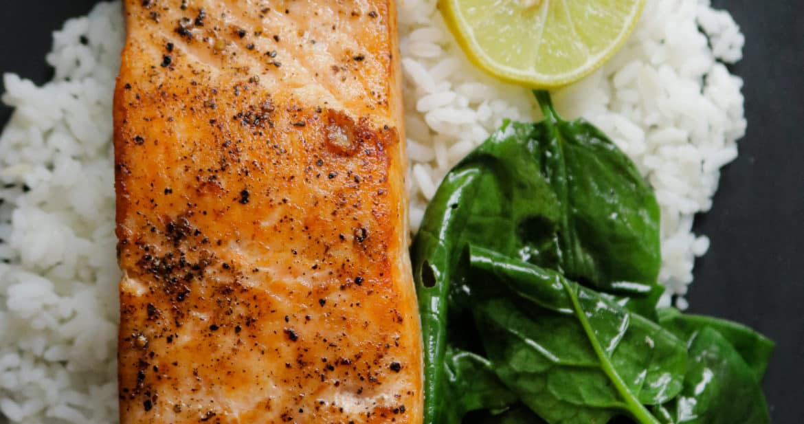 pan seared salmon serve with rice and spinach.