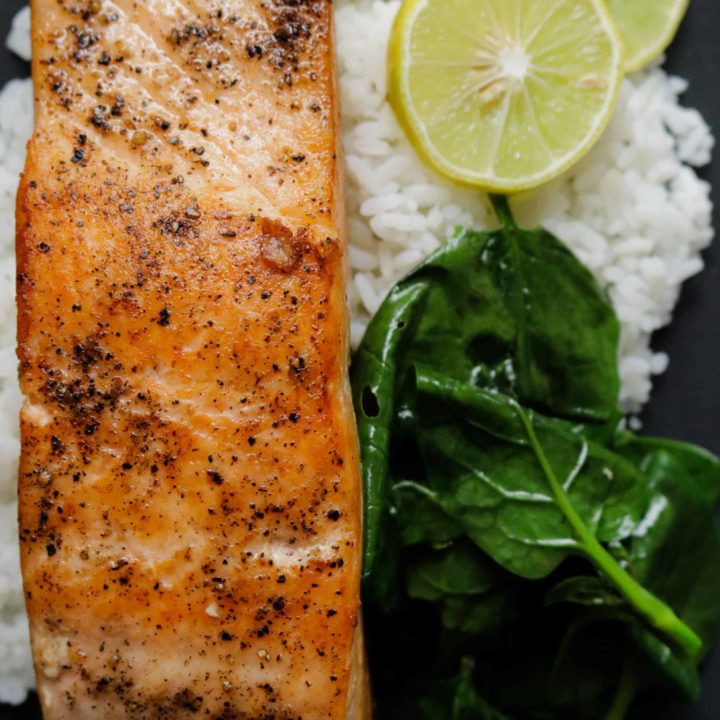 pan seared salmon serve with rice and spinach.