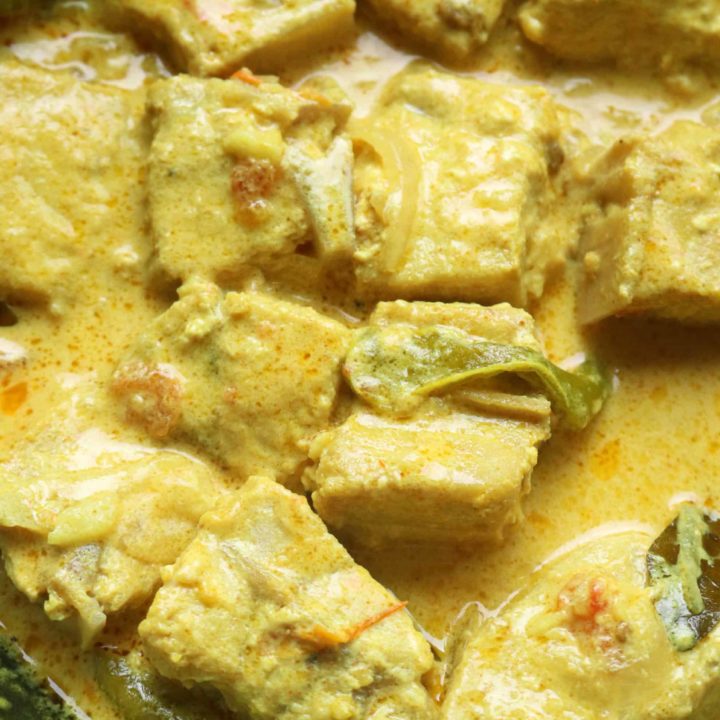 creamy coconut fish curry cooked in a bowl.