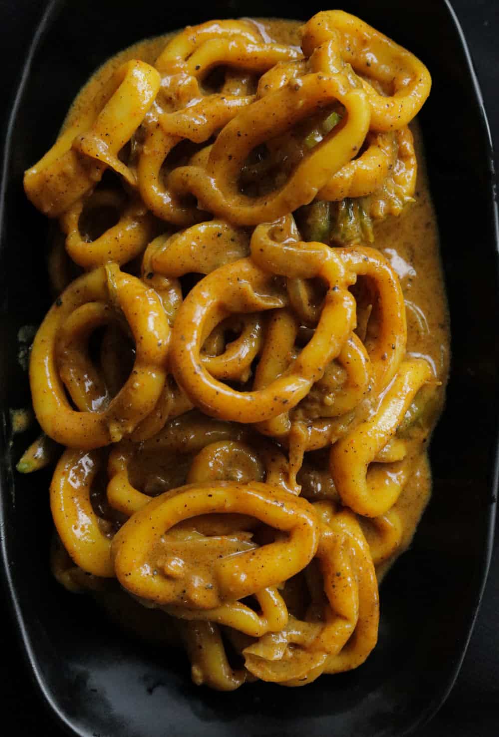 squid curry added into a plate to serve.