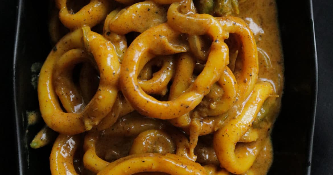 squid curry added into a plate to serve.