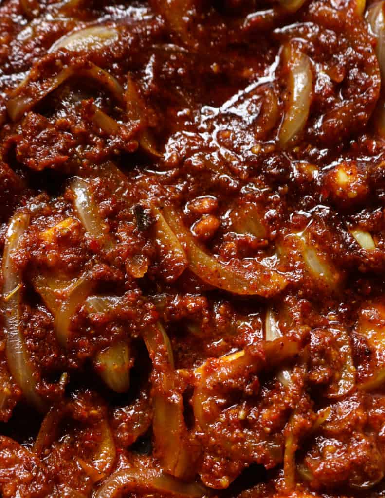 Onions and vindaloo paste cooked for the vindaloo curry.