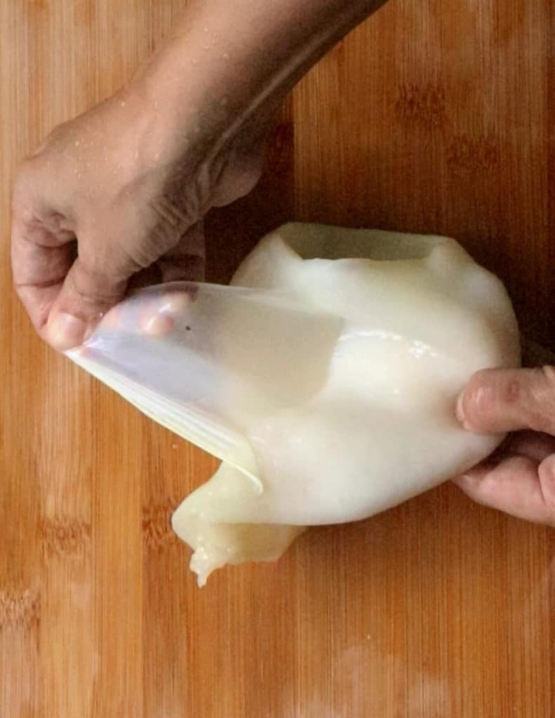 removing the transparent skin of the squid.