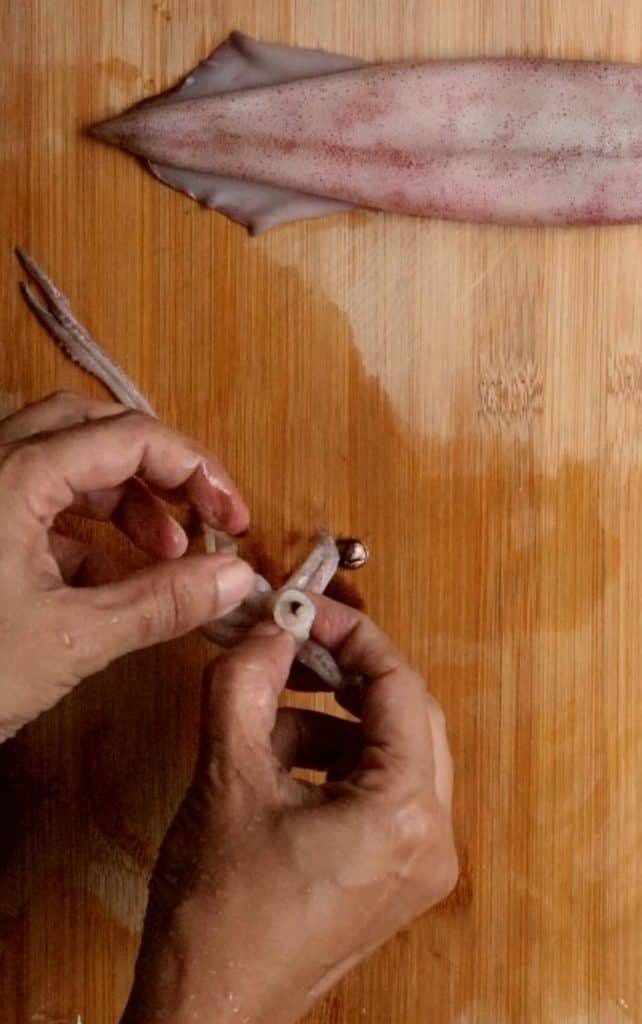 removing the beak from the head while cleaning the squid.